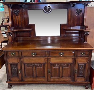 Lot 875 - An Art Nouveau carved mahogany mirror-back...