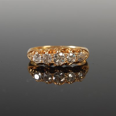 Lot 335 - An 18ct gold and diamond five stone ring, the...
