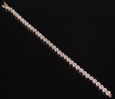 Lot 439 - A yellow metal and diamond set tennis type...