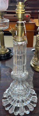 Lot 639 - A brass mounted heavy cut glass table lamp,...