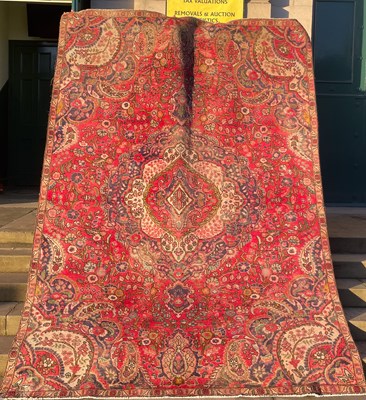 Lot 912 - A 20th century Persian rug, the madder ground...