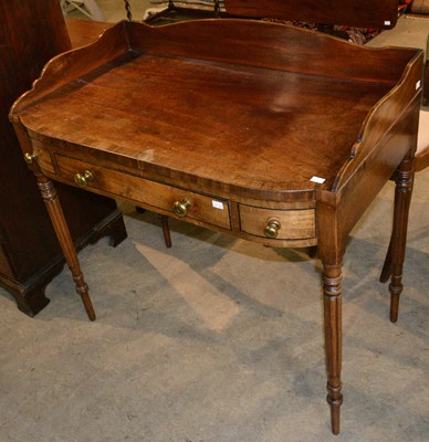 Lot 839 - A Regency bow fronted mahogany dressing table...