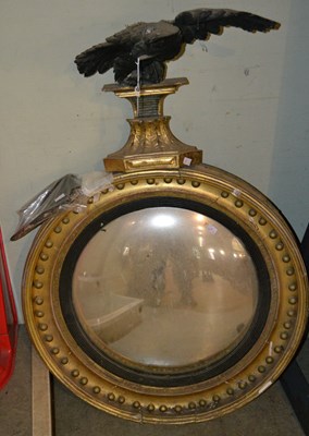 Lot 686 - A 19th century Regency giltwood convex wall...
