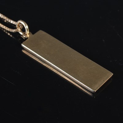 Lot 200 - A 9ct gold necklace suspending a 9ct gold...