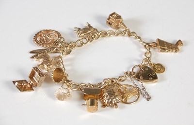 Lot 165 - A 9ct gold charm bracelet with 9ct gold heart...