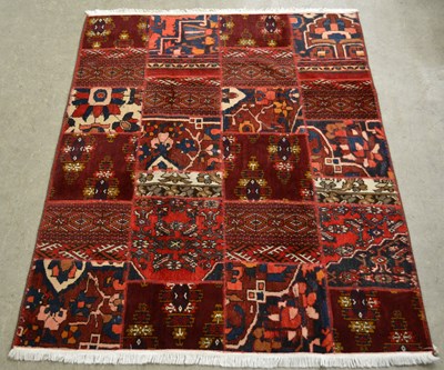 Lot 770 - A Persian patchwork carpet formed from four...
