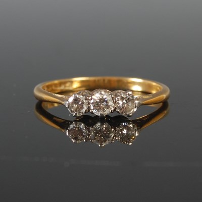 Lot 48 - A yellow and white metal three stone diamond...