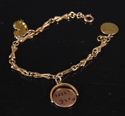 Lot 161 - A child's yellow metal charm bracelet...
