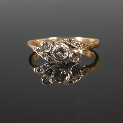 Lot 190 - A white and yellow metal three stone diamond...