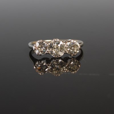 Lot 193 - A white metal three stone diamond ring,...