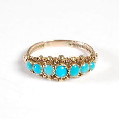 Lot 253 - A yellow metal and turquoise seven stone ring,...