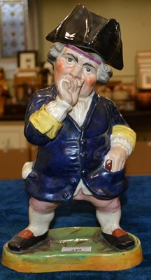 Lot 449 - A 19th century pottery figure of a gentleman...