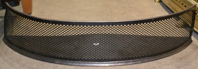 Lot 657 - A 19th century curved iron fire fender with...
