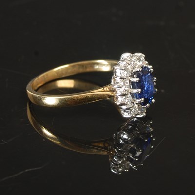 Lot 263 - An 18ct gold sapphire and diamond cluster ring,...