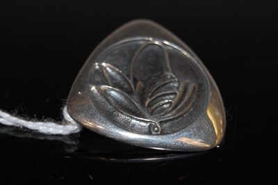 Lot 41 - A silver triangular-shaped brooch chased with...
