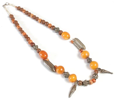 Lot 4 - An amber, white metal, coral and nut bead...