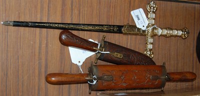 Lot 306 - A carved wooden dagger with brass accents in...
