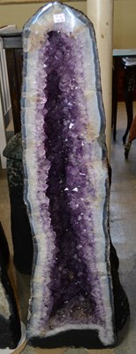 Lot 327E - A large amethyst cathedral geode, with purple...
