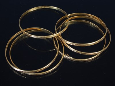 Lot 25 - Six high carat gold bangles, all stamped '22',...