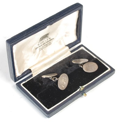 Lot 18 - A pair of white metal oval cufflinks, each...