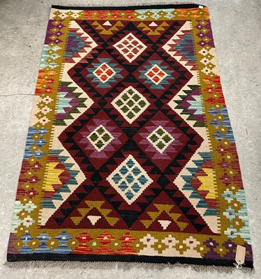Lot 670 - A Maimana Kilim rug, worked in burgundy, ochre,...