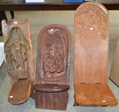 Lot 522 - Three hand carved African folding chairs,...