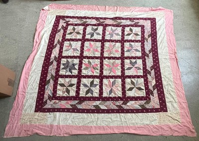 Lot 375 - A hand made patchwork quilt, featuring a...