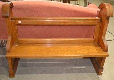 Lot 546 - A 20th century oak church pew, with curved...