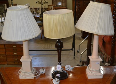 Lot 562 - A pair of painted pink wooden column table...