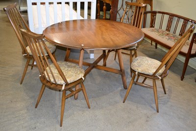 Lot 521 - A mid-century Ercol drop leaf dining table,...