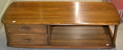Lot 517 - A mid-century Ercol coffee table, with two...