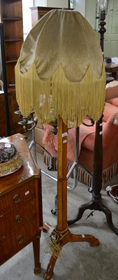 Lot 539 - A traditional wooden floor lamp, with a green...