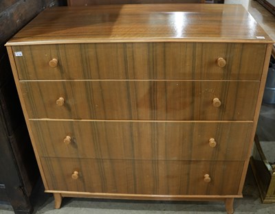 Lot 569 - A mid-century walnut four drawer chest, by...