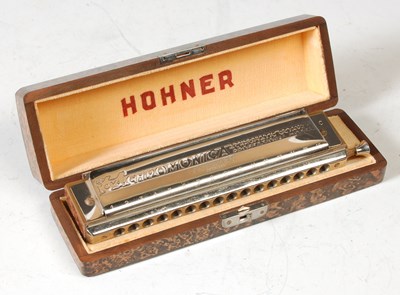 Lot 229 - An M. Hohner harmonica, featuring sixteen...