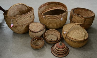 Lot 406 - A group of woven basket bowls, each decorated...