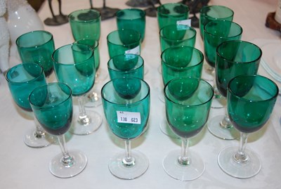 Lot 299 - A set of eighteen green and clear glass wine...