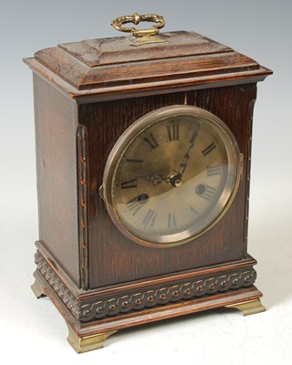 Lot 233 - An early 20th century oak mantle clock with...