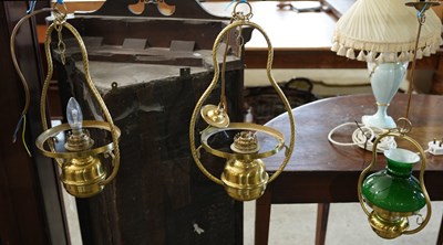 Lot 595 - A pair of 20th century brass hanging oil lamps...