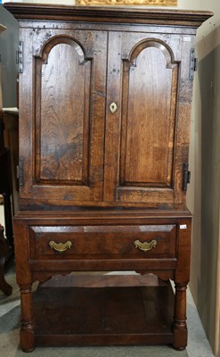 Lot 617 - An antique oak cupboard, with shaped cornice...