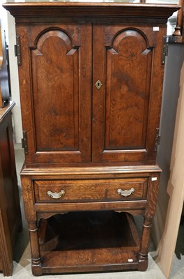 Lot 629 - An antique oak cupboard, the cornice above two...