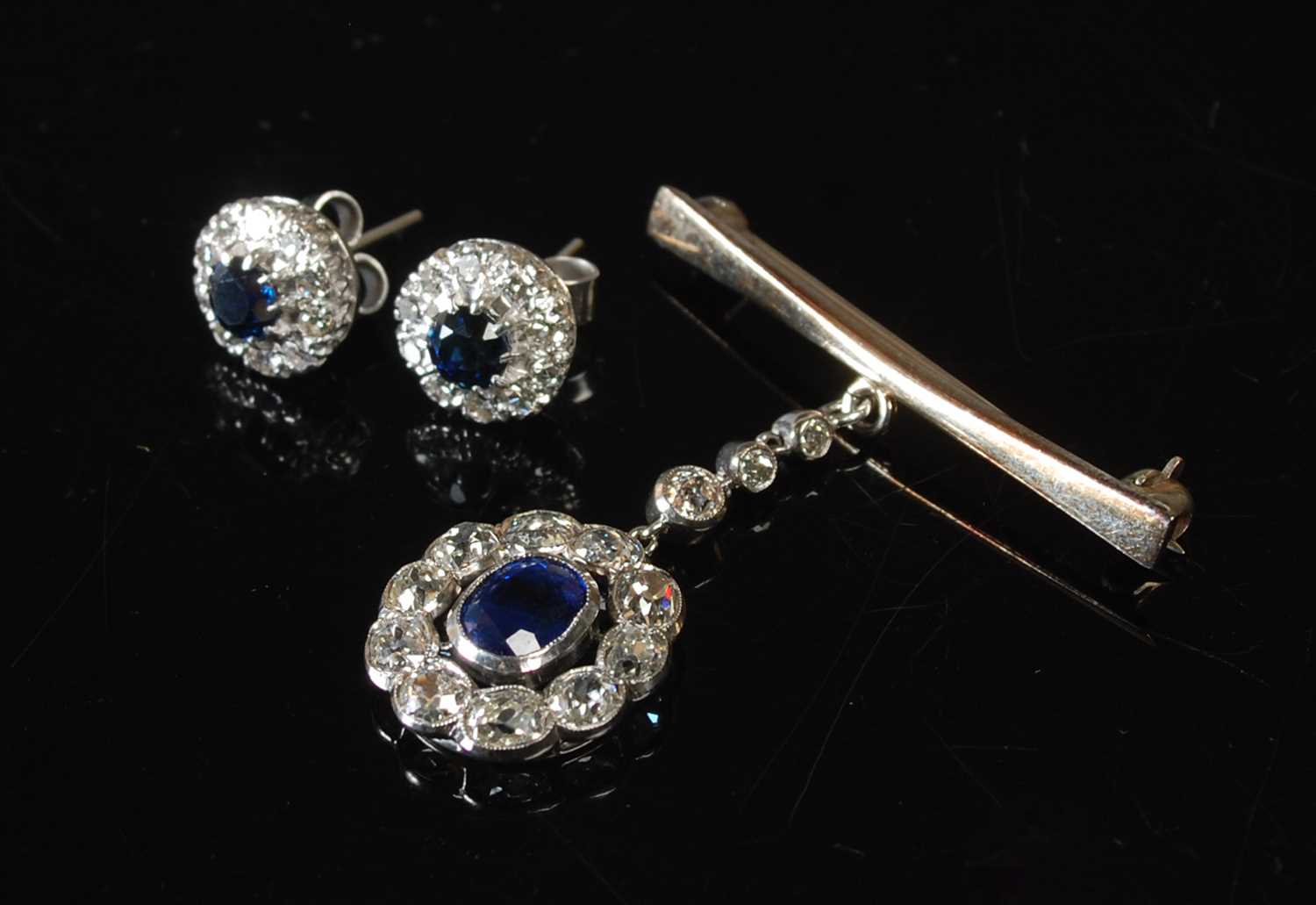 Lot 34 - A white metal sapphire and diamond pendant...