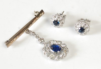 Lot 34 - A white metal sapphire and diamond pendant...