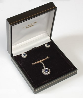 Lot 34 - A white metal sapphire and diamond pendant...