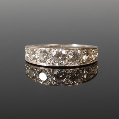 Lot 56 - An 18ct white gold and diamond half hoop ring...