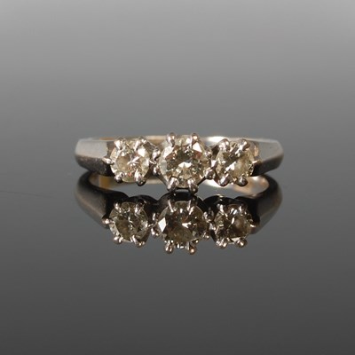 Lot 57 - An 18ct white gold and diamond three stone...