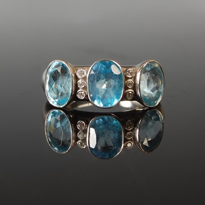 Lot 51 - A platinum diamond and blue topaz cocktail...