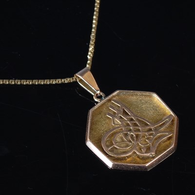 Lot 6 - An 18ct gold necklace, suspending a 14ct gold...