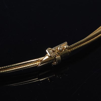 Lot 11 - A triple strand 18ct gold necklace, stamped...