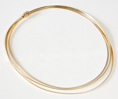 Lot 11 - A triple strand 18ct gold necklace, stamped...
