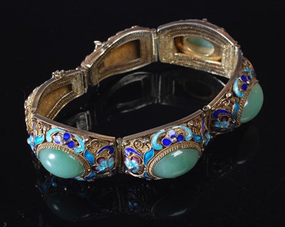 Lot 21 - A Chinese silver gilt enamel and green...
